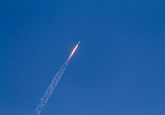 flying rocket during daytime